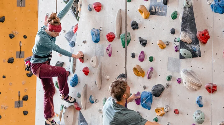 Boulder und Indoor-Klettern ist bei vielen DAV-Sektionen möglich | © DAV/Marisa Koch Zwei Personen bouldern nebeneinander an einer Boulderwand | © DAV/Marisa Koch